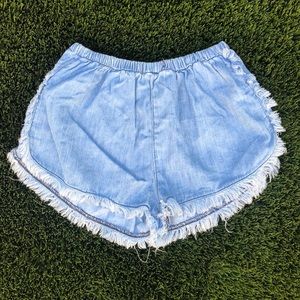 High waisted light washed denim fringe shorts